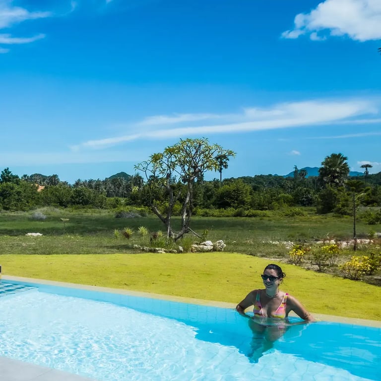 The pool at Baan Mahasamut Pranburi with the mountain backdrop during sunny day
